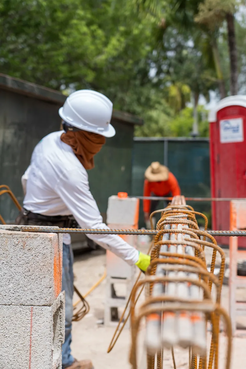 Crew member placing reinforcing steel at the Kaēlo Residence, Miami Shores